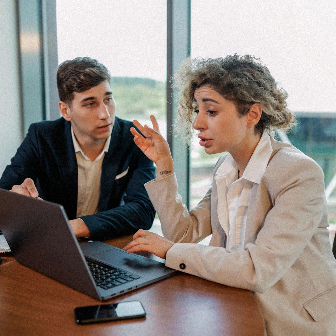 Two executives reviewing an investment file
