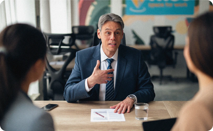 A manager in conversation with two colleagues