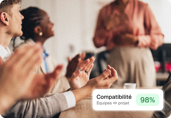 A team applauding, with a 98% compatibility indicator