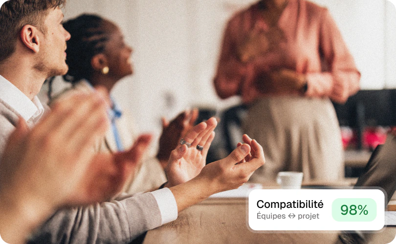 A team applauding, with a 98% compatibility indicator