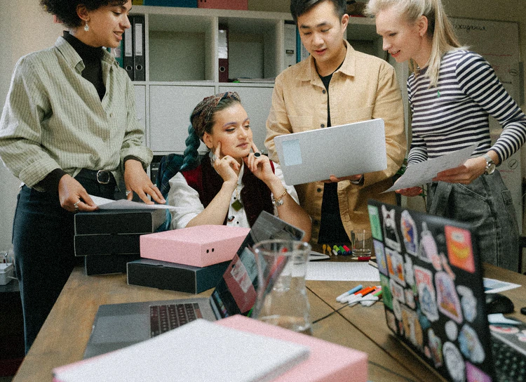 A team gathered around a work table
