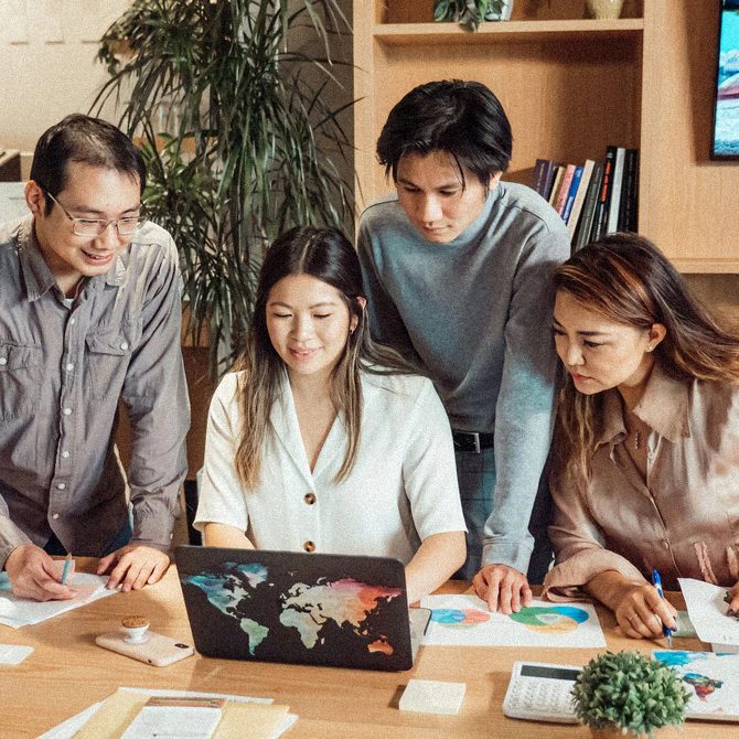 A team gathered around a work table