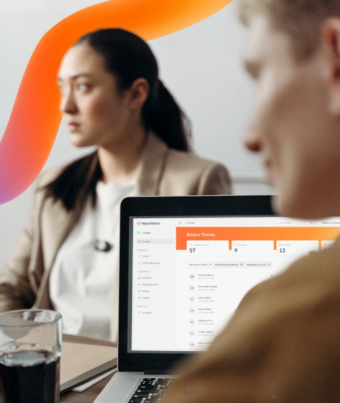 Two colleagues in a meeting with the Map & Match platform open on a laptop