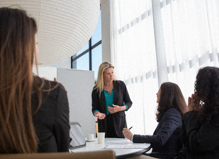 A facilitator in front of a team in a workshop